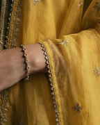 Yellow embroidered traditional outfit with a dark background